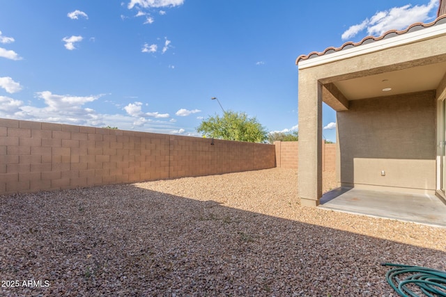 view of yard with a fenced backyard and a patio area