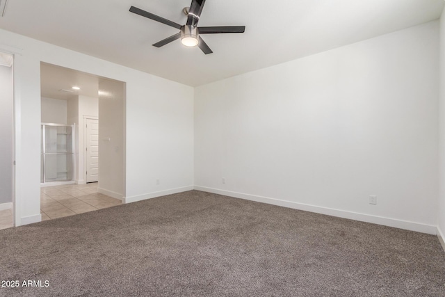 spare room featuring light colored carpet, baseboards, and ceiling fan