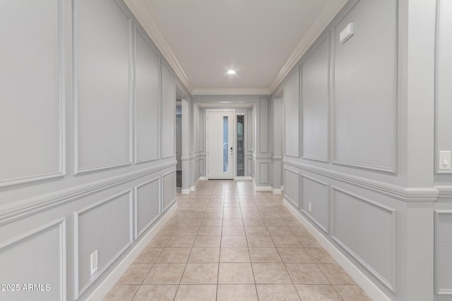 hallway with crown molding, light tile patterned floors, a decorative wall, and recessed lighting