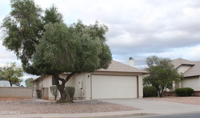 view of front of property featuring stucco siding, fence, concrete driveway, a garage, and a chimney