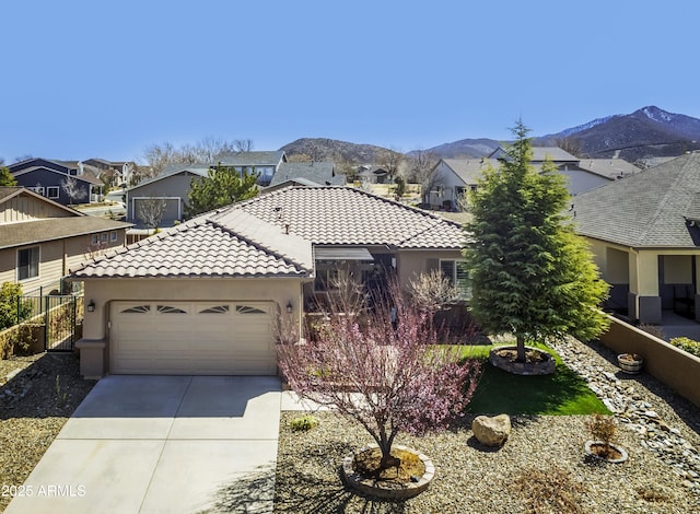 ranch-style house with stucco siding, driveway, an attached garage, and a tile roof