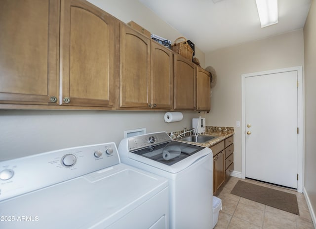 6975 E Lynx Wagon Rd, Prescott Valley, AZ 86314 - clothes washing area with washer and clothes dryer, a sink, cabinet space, light tile patterned floors, and baseboards
