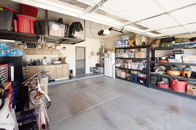 6975 E Lynx Wagon Rd, Prescott Valley, AZ 86314 - garage featuring a garage door opener and freestanding refrigerator