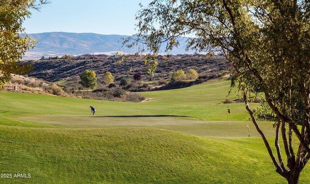6975 E Lynx Wagon Rd, Prescott Valley, AZ 86314 - view of property's community with view of golf course, a yard, and a mountain view