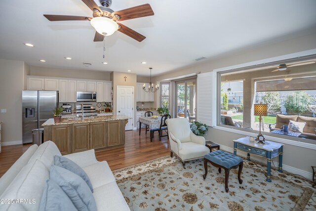 6975 E Lynx Wagon Rd, Prescott Valley, AZ 86314 - living area with ceiling fan with notable chandelier, recessed lighting, wood finished floors, and baseboards