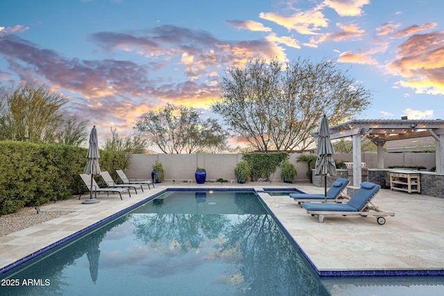 pool at dusk with a pergola and a patio