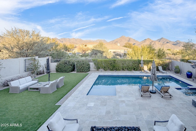 view of pool with a yard, an outdoor hangout area, a patio area, and a mountain view