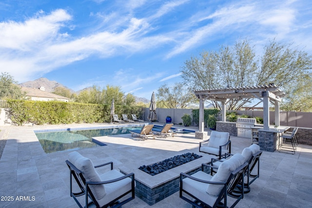 view of patio / terrace with a pergola, area for grilling, a bar, a fire pit, and a fenced in pool