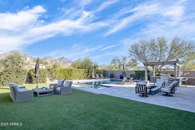 view of pool featuring a yard, an outdoor hangout area, a pergola, a mountain view, and a patio area