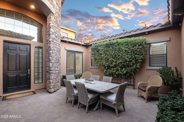 view of patio terrace at dusk