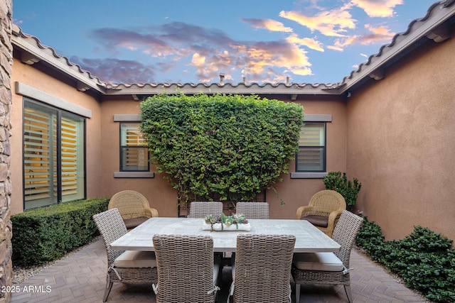 view of patio terrace at dusk