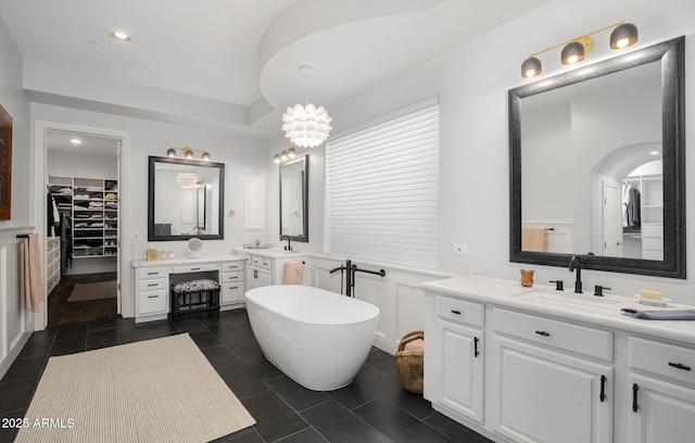 bathroom with a bathtub, vanity, and tile patterned floors