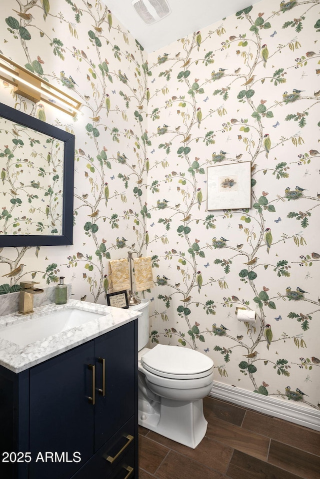 bathroom featuring toilet and vanity