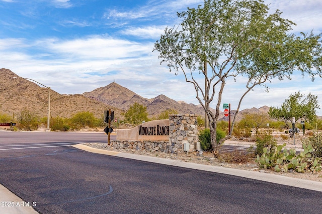 community sign with a mountain view