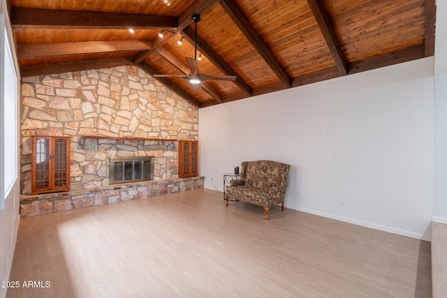 405 E Stanford Ave, Gilbert, AZ 85234 - unfurnished room featuring wooden ceiling, wood finished floors, ceiling fan, a stone fireplace, and baseboards