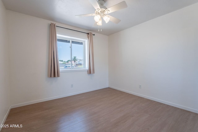 405 E Stanford Ave, Gilbert, AZ 85234 - unfurnished room featuring wood finished floors, baseboards, and ceiling fan