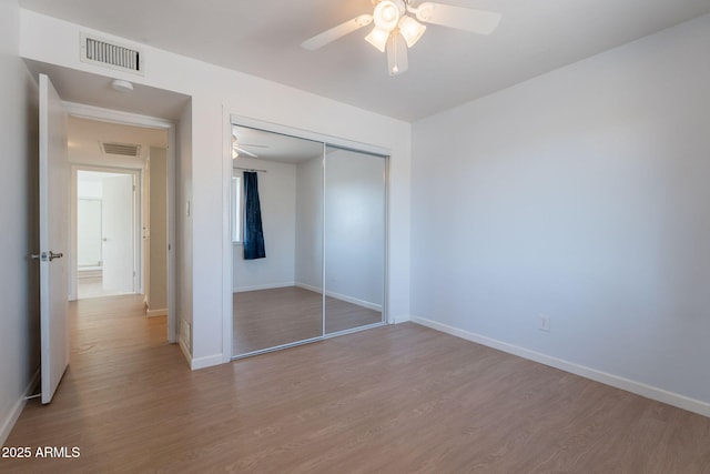 405 E Stanford Ave, Gilbert, AZ 85234 - unfurnished bedroom with wood finished floors, a closet, and baseboards