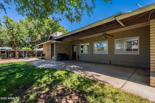 405 E Stanford Ave, Gilbert, AZ 85234 - view of side of home with a ceiling fan, a patio area, a chimney, and brick siding