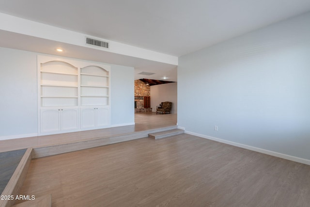405 E Stanford Ave, Gilbert, AZ 85234 - unfurnished living room featuring a fireplace, wood finished floors, and baseboards