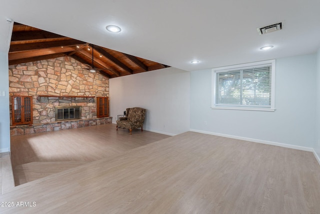 405 E Stanford Ave, Gilbert, AZ 85234 - unfurnished living room featuring wood finished floors, a stone fireplace, and baseboards