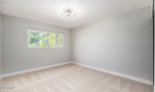 12431 N 30th Ave, Phoenix, AZ 85029 - spare room with a chandelier and light colored carpet