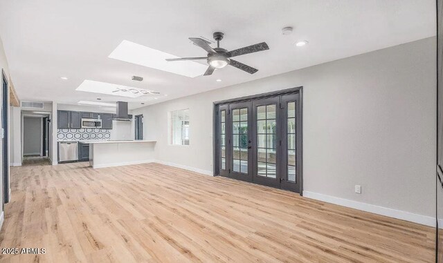 12431 N 30th Ave, Phoenix, AZ 85029 - unfurnished living room with a skylight, light wood-type flooring, ceiling fan, and recessed lighting