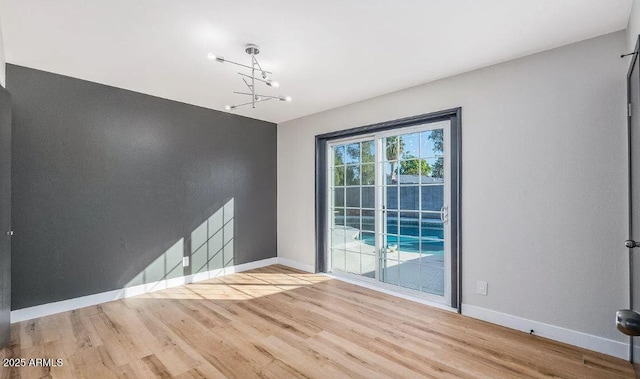 12431 N 30th Ave, Phoenix, AZ 85029 - unfurnished dining area featuring wood finished floors and a chandelier