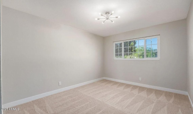 12431 N 30th Ave, Phoenix, AZ 85029 - spare room featuring light colored carpet and a chandelier