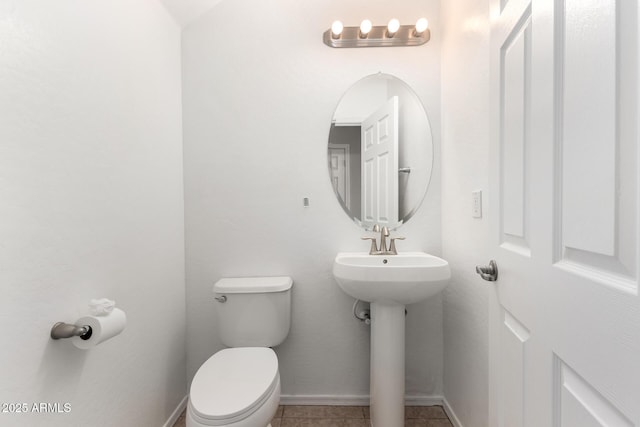 bathroom with sink, toilet, and tile patterned flooring