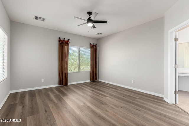 empty room with ceiling fan and wood-type flooring