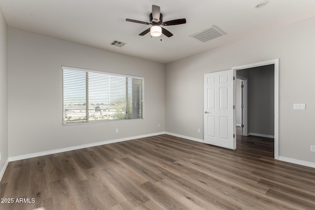 unfurnished room with ceiling fan and dark hardwood / wood-style flooring