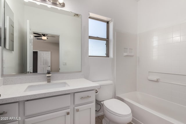 full bathroom featuring toilet, ceiling fan,  shower combination, and vanity