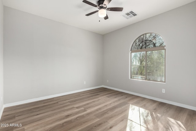 unfurnished room with ceiling fan and hardwood / wood-style flooring