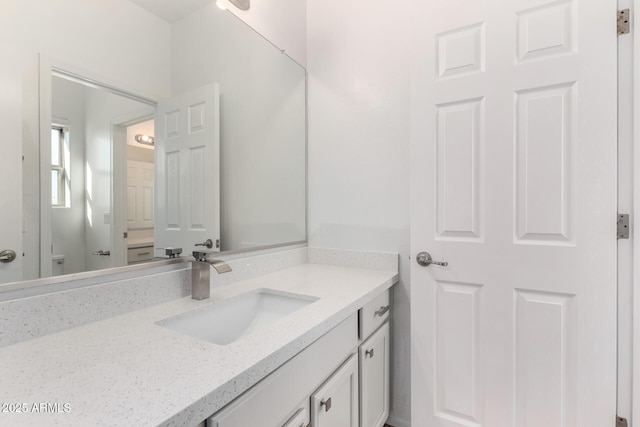 bathroom with toilet and vanity