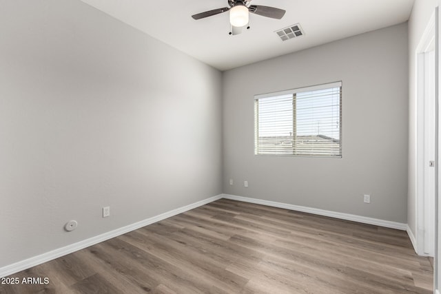 spare room with ceiling fan and wood-type flooring