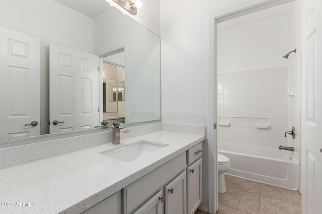 full bathroom featuring toilet, vanity,  shower combination, and tile patterned flooring