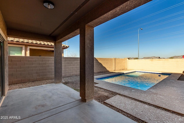 view of swimming pool featuring a patio area