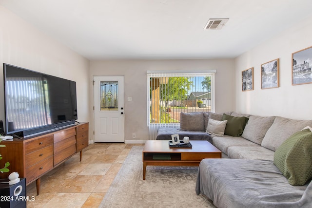 living room with baseboards and visible vents