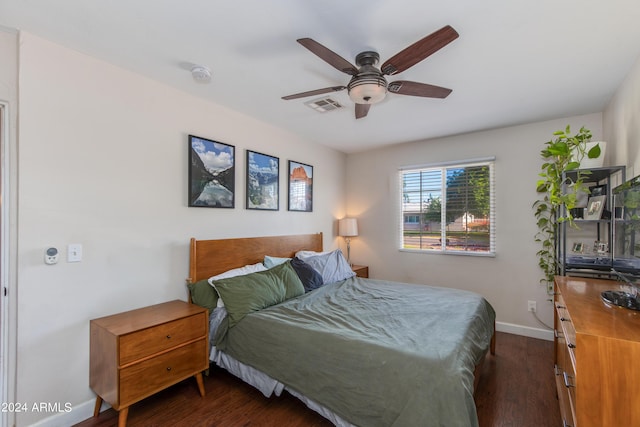 bedroom with a ceiling fan, baseboards, visible vents, and dark wood-style flooring