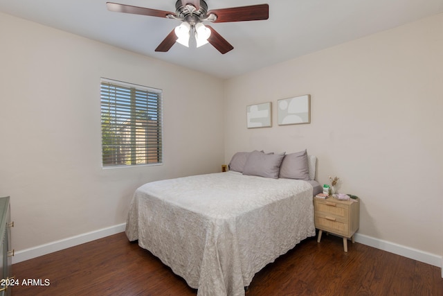 bedroom with dark wood-style floors, ceiling fan, and baseboards