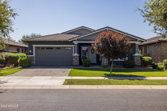 craftsman inspired home featuring a front lawn and a garage