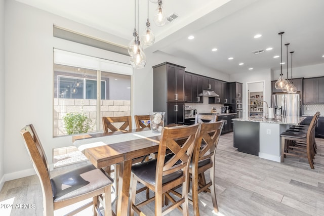 dining space featuring light wood-type flooring