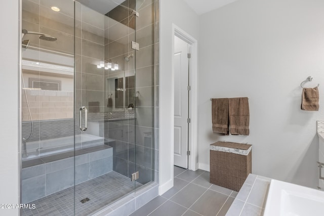 bathroom with walk in shower and tile patterned floors