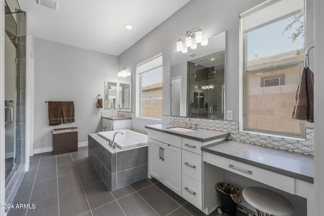 bathroom with backsplash, vanity, shower with separate bathtub, and tile patterned flooring