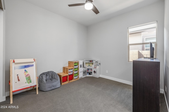 rec room with dark carpet and ceiling fan