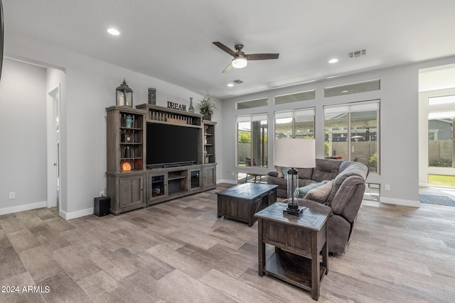 living room with ceiling fan and light wood-type flooring