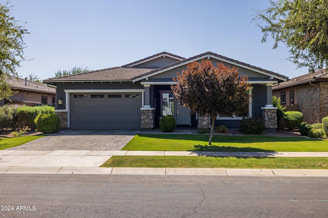 craftsman-style house featuring a garage and a front yard