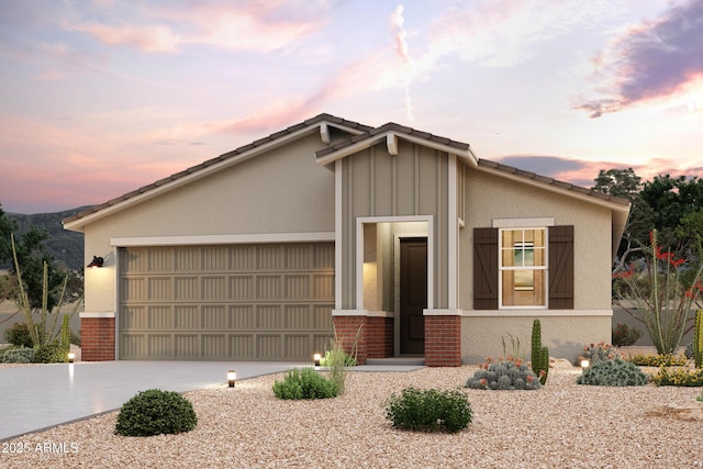 mid-century inspired home with a garage, brick siding, and driveway