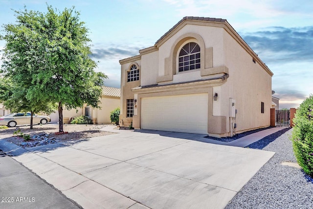 mediterranean / spanish-style house with a garage