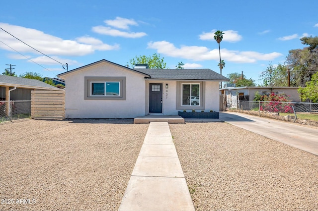 view of front of house with fence and stucco siding